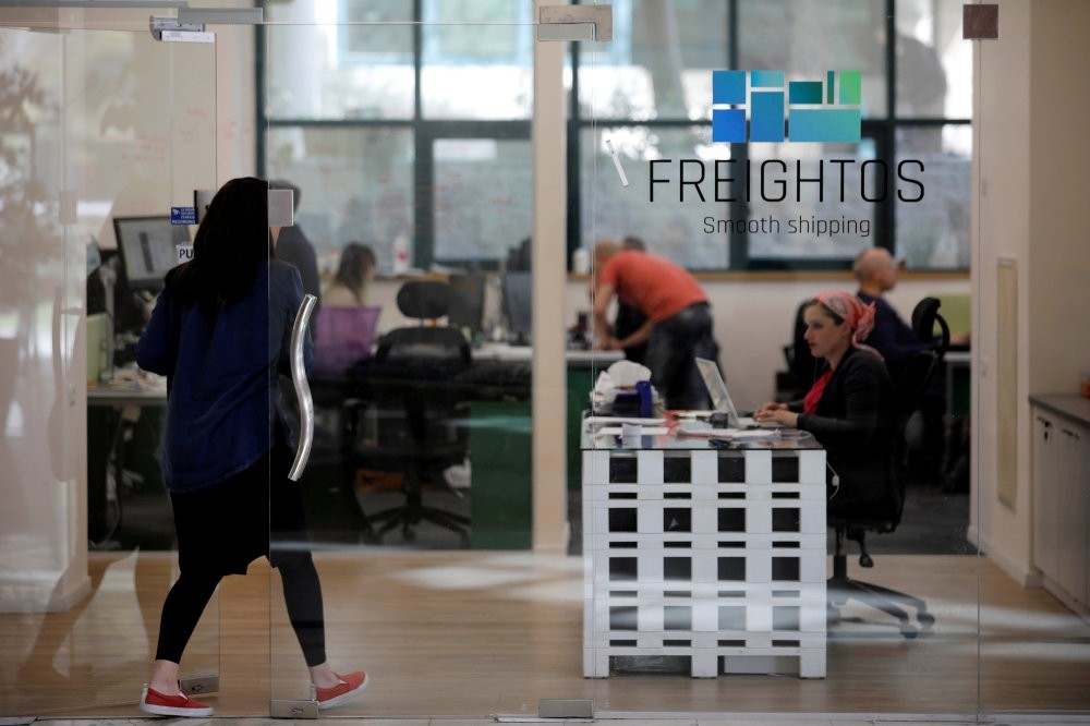 A woman enters the offices of Freightos, an online marketplace for international shipping, with investors including Sadara Ventures.