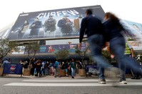 Visitors walk to the Festival Palace to attend the annual MIPCOM television program market in Cannes, France, Oct. 15, 2018.