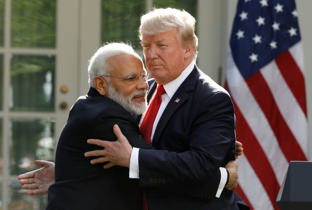 India's Prime Minister Narendra Modi hugs U.S. President Donald Trump as they give joint statements in the Rose Garden of the White House.