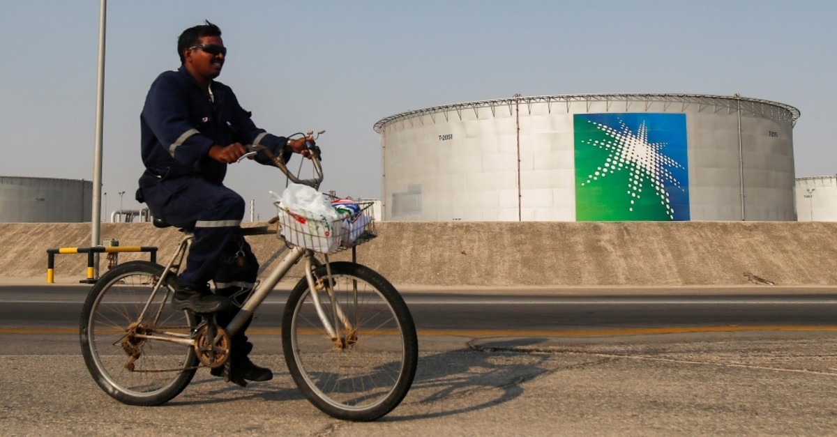 An employee rides a bicycle next to oil tanks at the Saudi Aramco oil facility in Abqaiq, Saudi Arabia, Oct. 12, 2019. (Reuters Photo)