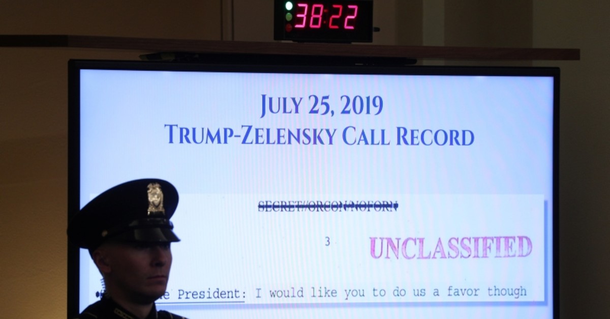 A U.S. Capitol police officer watches from in front of a video monitor displaying part of the call record of U.S. President Donald Trump's phone call with Ukraine's President Volodymyr Zelenskiy (Reuters Photo)