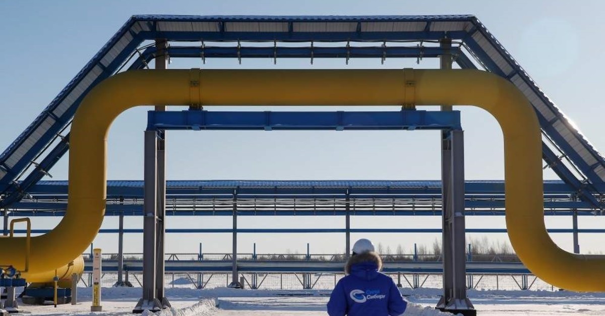 An employee in branded jacket walks past a part of Gazprom's Power Of Siberia gas pipeline at the Atamanskaya compressor station outside the far eastern town of Svobodny, Amur region, Russia, Nov. 29, 2019. (Reuters Photo)