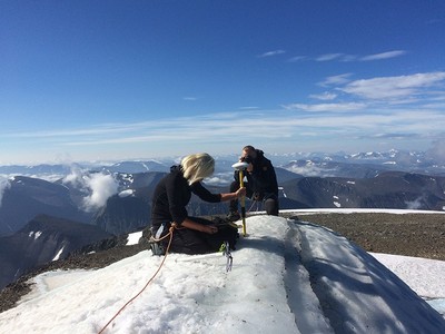 A handout picture released by Stockholm University on Aug. 1, 2018, and taken on July 31, 2018, shows Gunhild Ninis Rosqvist, a Stockholm University geography professor making measurements atop Sweden's highest peak, a glacier on the southern tip of the Kebnekaise mountain in northern Sweden. (AFP Photo)