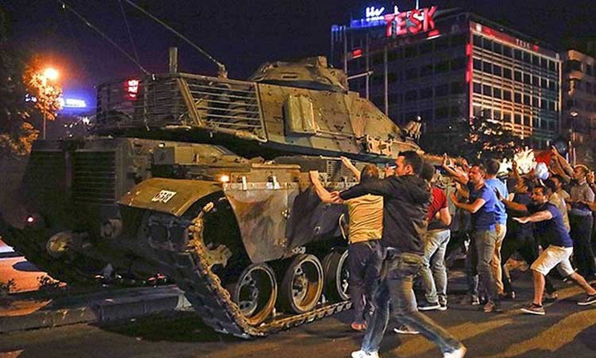 People try to stop a tank commanded by putschists in Ankara on July 15, 2016.
