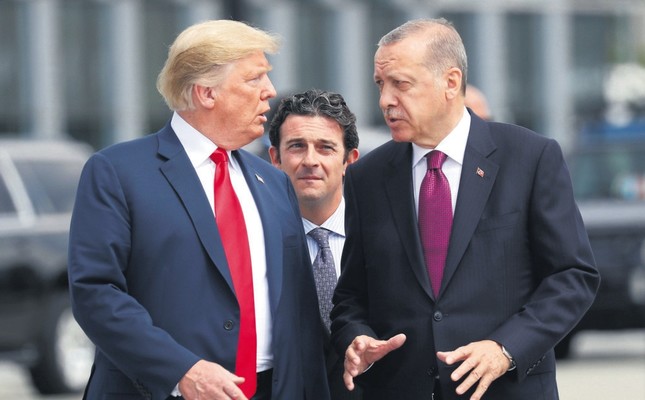 President Recep Tayyip ErdoÄan and U.S. President Donald Trump (L) talk as they walk during the start of the NATO summit in Brussels, Belgium, July 11, 2018.
