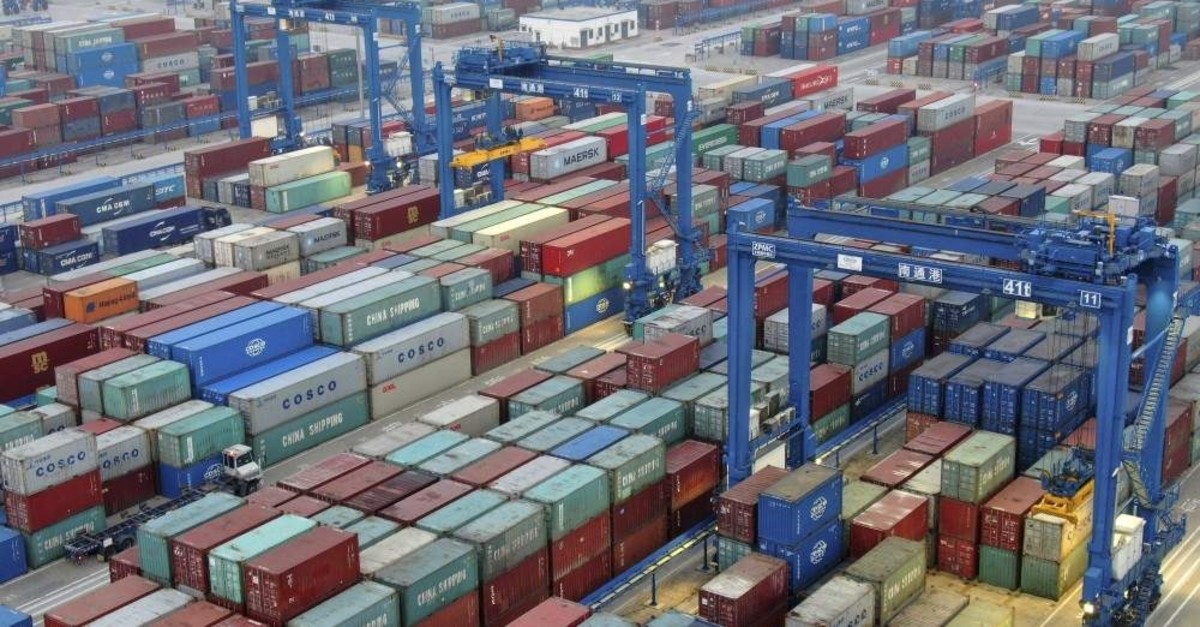 In this Jan. 14, 2020, photo, shipping containers are stacked at a dockyard on the Yangtze River in Nantong in eastern China's Jiangsu Province. (AP Photo)