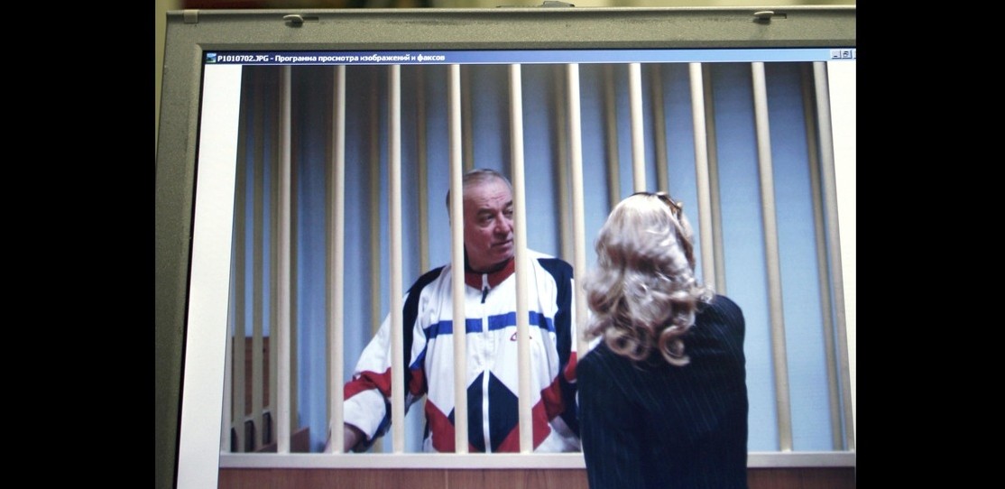 In this Wednesday, Aug. 9, 2006 file photo, Sergei Skripal speaks to his lawyer from behind bars seen on a screen of a monitor outside a courtroom in Moscow. (AP Photo)