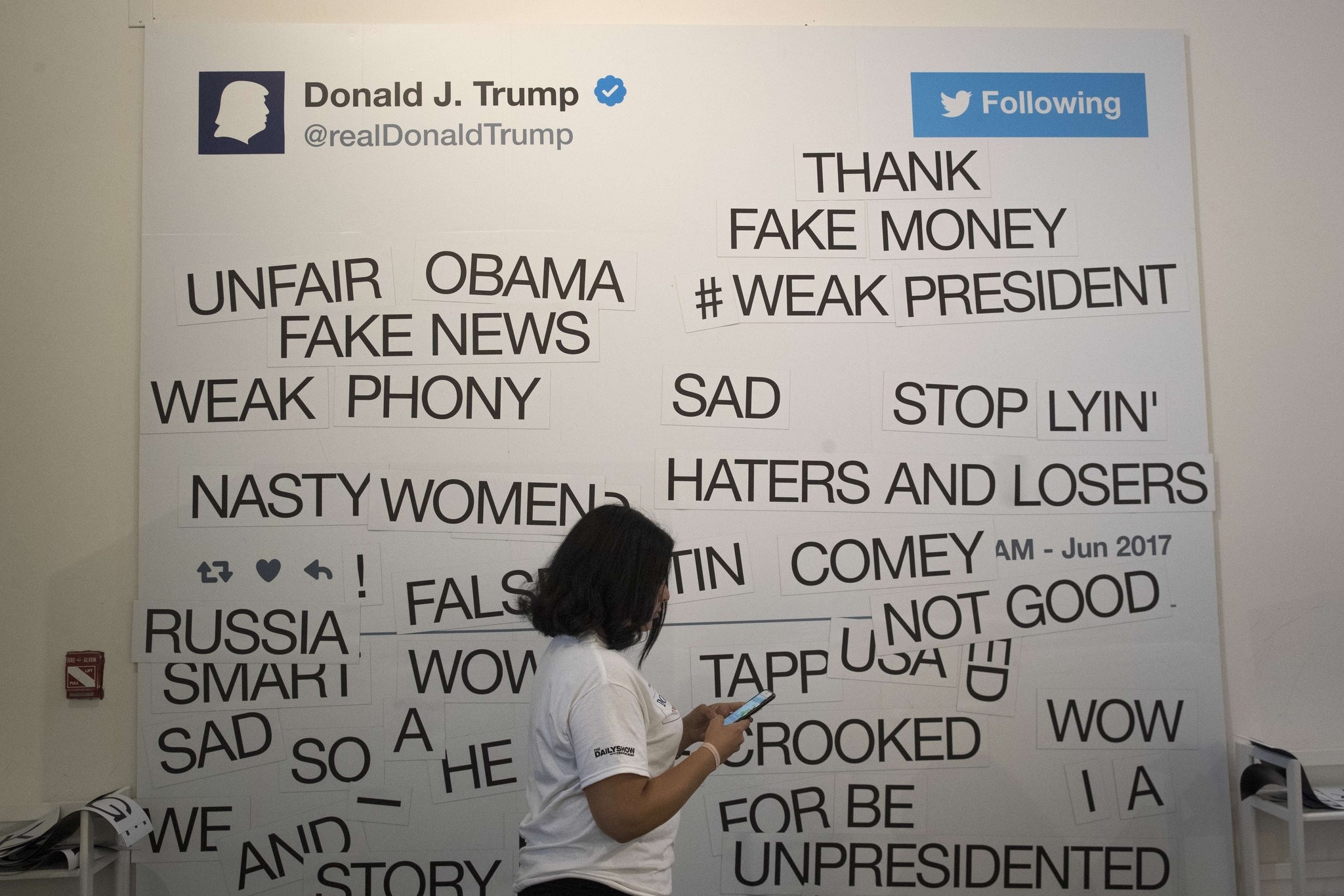 Guests can create their own tweets on a magnetic wall at The Daily Show-produced 'Donald J. Trump Presidential Twitter Library,' June 16, 2017 in New York City.