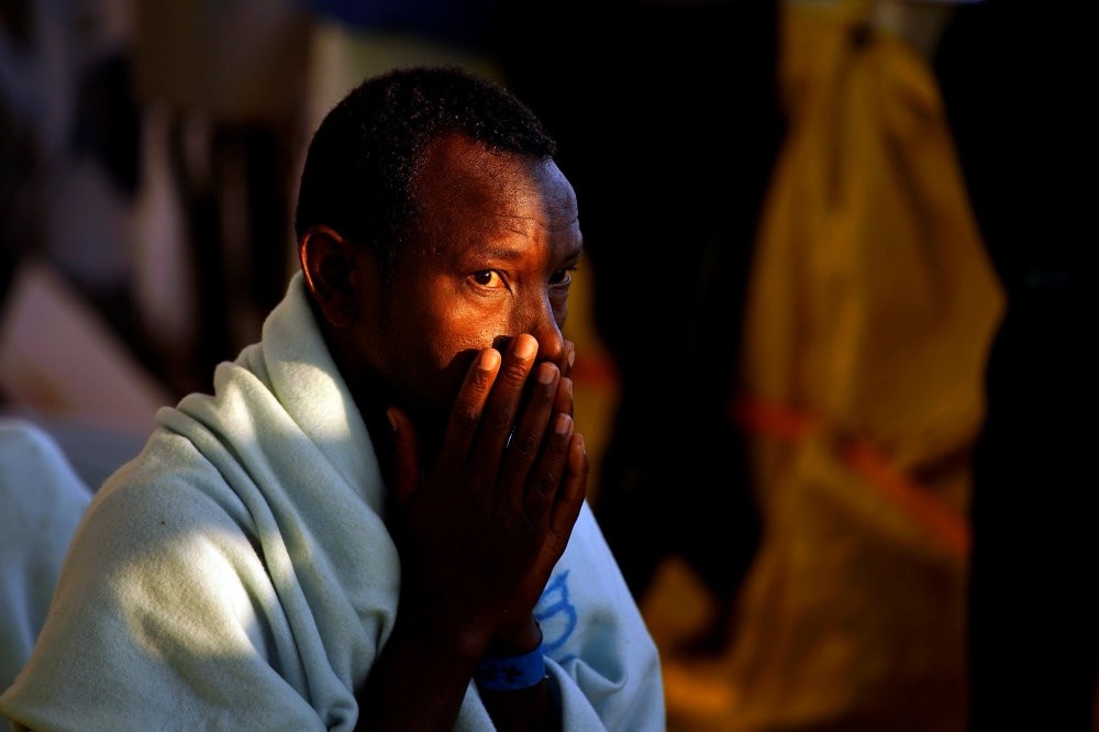 A migrant prays on a rescue boat in the central Mediterranean Sea, Aug. 6.