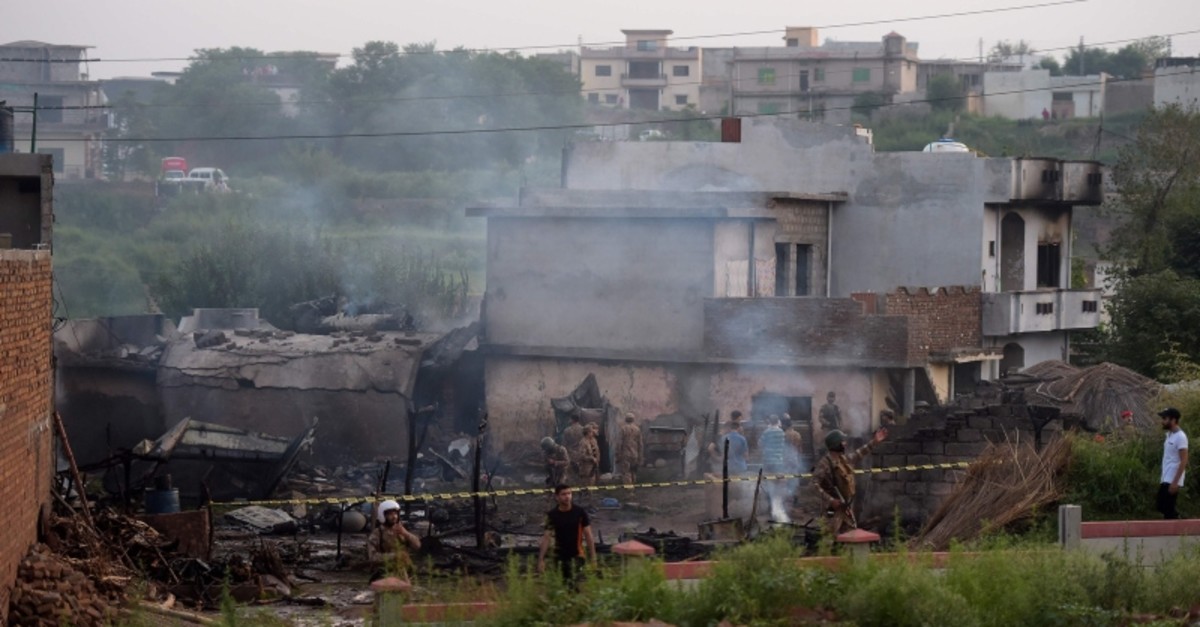 Soldiers cordon off the site where a Pakistani Army Aviation Corps aircraft crashed in Rawalpindi on July 30, 2019. (AFP Photo)