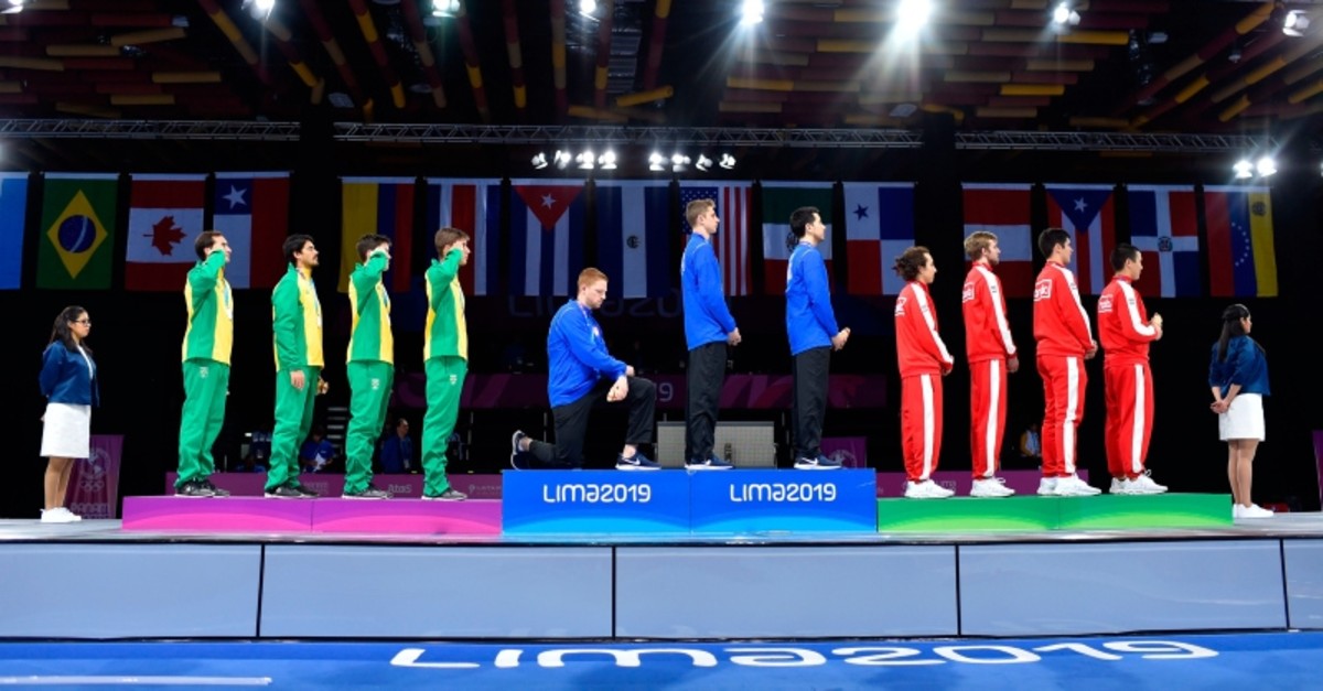 U.S.' Race Imboden (4th from L) kneels during the national anthem at the Men's Foil Team medal ceremony in Fencing, at the Lima Convention Center during the Pan American Games Lima 2019 in Lima on Aug. 9, 2019. (AFP Photo)