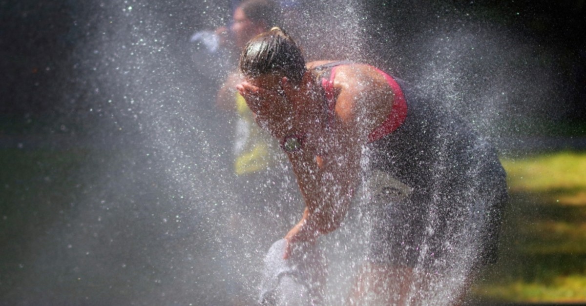 Firefighters spray water on runners at a half marathon in Hamburg, Germany, Sunday, June 30, 2019. (AP Photo)