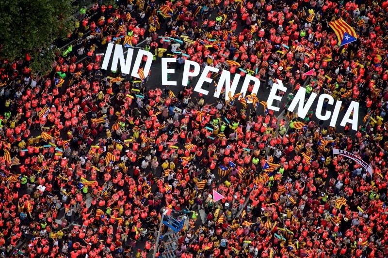 This handout picture released by the Assemblea Nacional Catalana (Catalan National Assembly) shows an aerial view of people holding letters reading ,Independence, during a pro-independence demonstration, on September 11, 2018 in Barcelona. (AFP Phot)