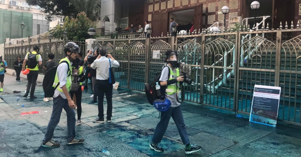 Members of the press are seen outside the Kowloon Masjid and Islamic Centre in Hong Kong, China, after police doused it with a water cannon, on October 20, 2019 in this picture obtained from social media.  (Jeremy Tam/Civic Party via Reuters Photo)