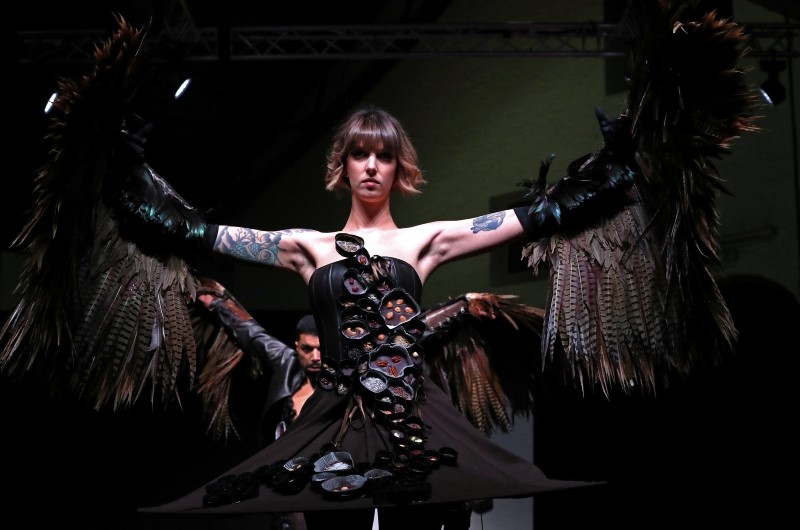 A model dressed in an outfit made with chocolate presents a creation at the
