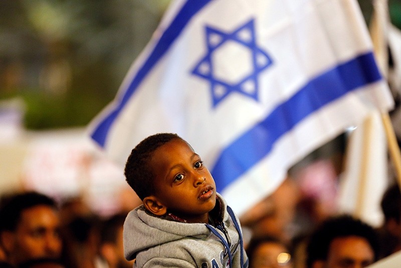 A boy takes part in a protest against the Israeli government's plan to deport African migrants, in Tel Aviv, Israel March 24, 2018. (Reuters Photo)