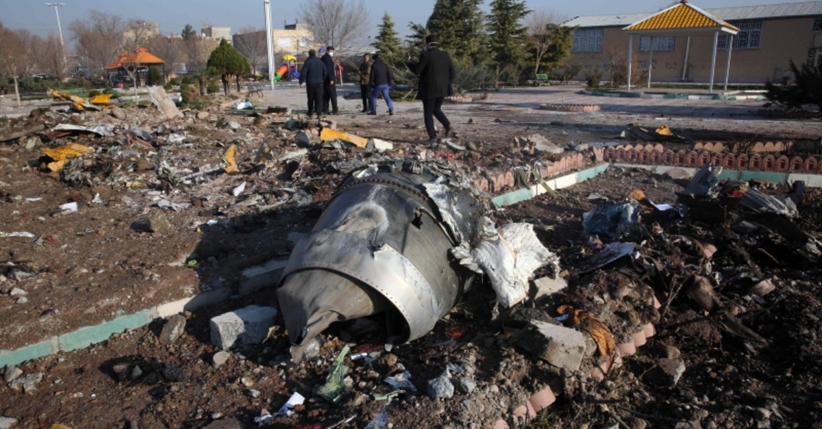 Rescue teams work amidst debris after a Ukrainian plane carrying 176 passengers crashed near Imam Khomeini airport in the Iranian capital Tehran early in the morning on January 8, 2020, killing everyone on board. (AFP Photo)