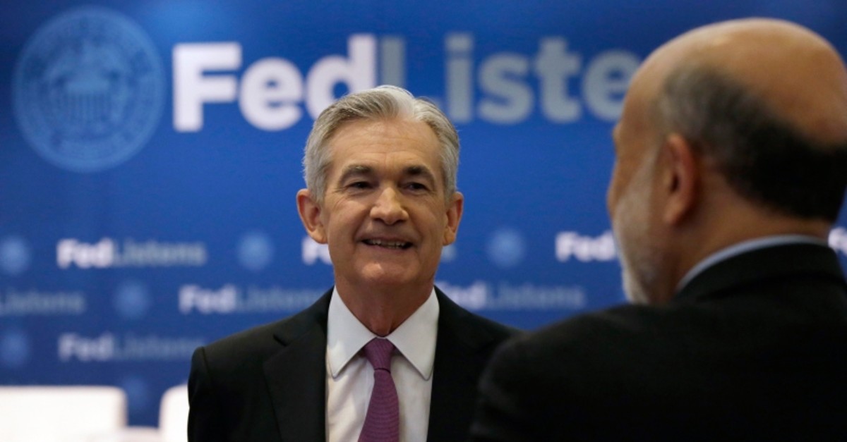 U.S. Federal Reserve Chairman Jerome Powell, left, talks to former Federal Reserve Chairs Ben Bernanke at a conference involving its review of its interest-rate policy strategy and communications, Tuesday, June 4, 2019, in Chicago. (AP Photo)