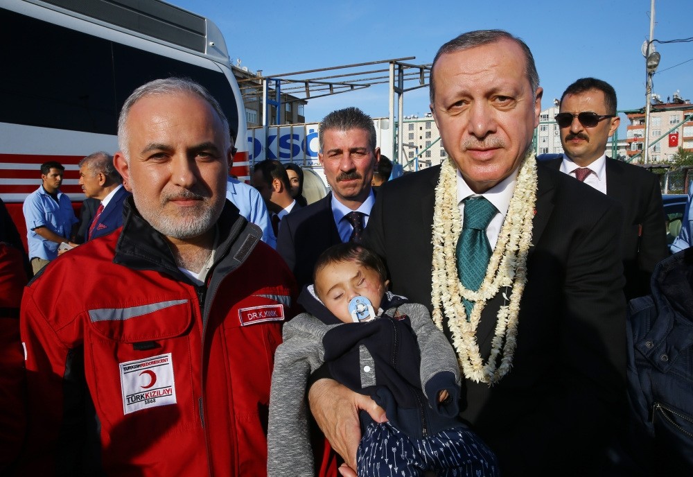 Baby Karim with President Erdou011fan (R) and Kerem Ku0131nu0131k, head of the Turkish Red Crescent. 