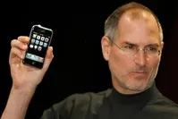  Late Apple founder Steve Jobs holds the very first iPhone (AFP Photo) 