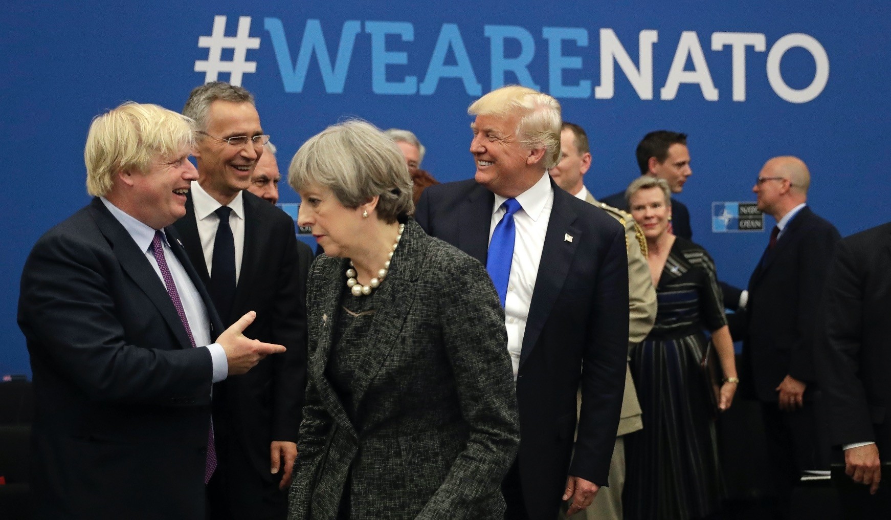 U.S. President Donald Trump jokes with then-Foreign Minister Boris Johnson of the U.K., as British Prime Minister Theresa May walks past during the annual summit at NATO headquarters, Brussels,  2017. 
