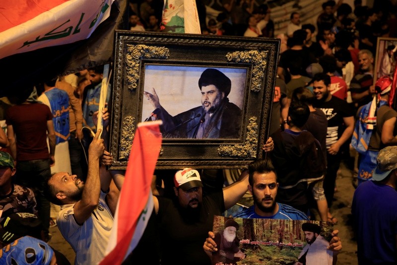 Supporters of Muqtada al-Sadr celebrate initial election results in Baghdad's Tahrir Square, on May 14, 2018. (AA Photo)