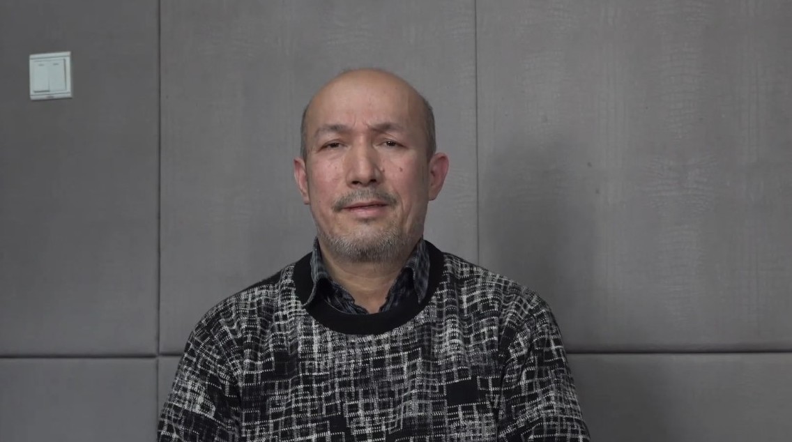 Screengrab from video released by China Radio International's Turkish language service showing a man dressed in a grey sweater identifying himself as Heyit. 