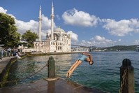 A young man jumps into the sea amid soaring temperatures, Istanbul, Aug. 3, 2019. (AA Photo) 