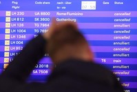 A passenger stands in front of the departure board at the airport in Frankfurt, Germany, Friday, Nov. 25, 2016. (AP Photo)