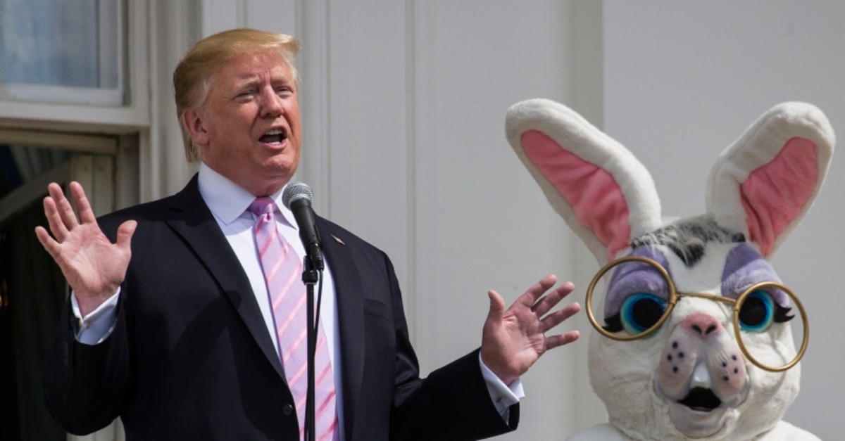 President Donald Trump, joined by the Easter Bunny, speaks from the Truman Balcony of the White House in Washington, Monday, April 22, 2019, during the annual White House Easter Egg Roll. (AP Photo)