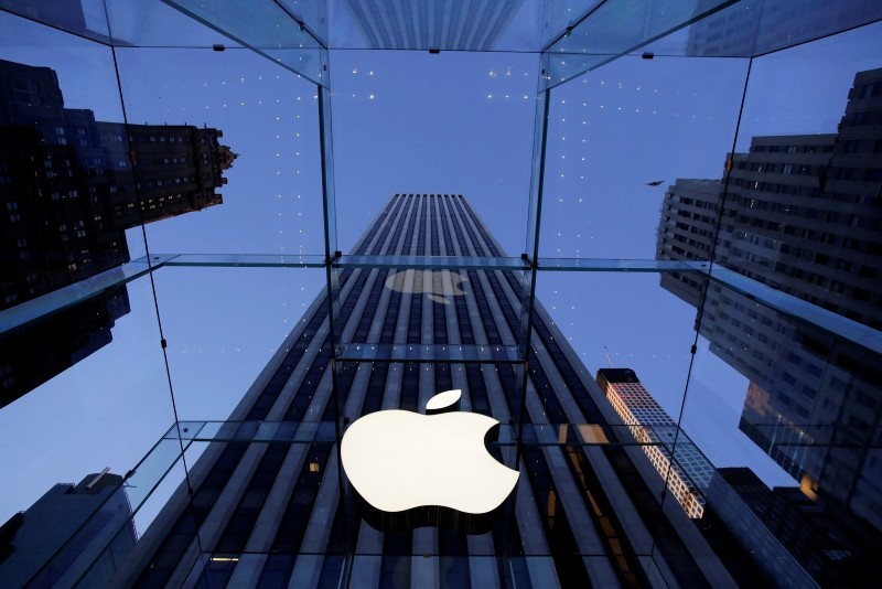 In this Sept. 5, 2014 photo, the Apple logo hangs in the glass box entrance to the company's Fifth Avenue store, in New York. Apple on Wednesday, Oct. 8, 2014 sent invites to an Oct. (AP Photo)