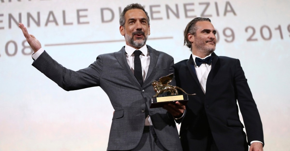 Director Todd Phillips, left, holds the Golden Lion for Best Film for 'Joker', joined by lead actor Joaquin Phoenix at the closing ceremony of the 76th Venice Film Festival, Venice, Italy, Saturday, Sept. 7, 2019. (Photo by Joel C Ryan/Invision/AP)