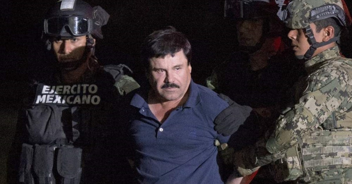 In this Jan. 8, 2016 file photo, army soldiers escort Mexican drug lord Joaquin ,El Chapo, Guzman to a waiting helicopter at a federal hangar in Mexico City after his escape from a maximum-security prison in Mexico. (AP Photo)