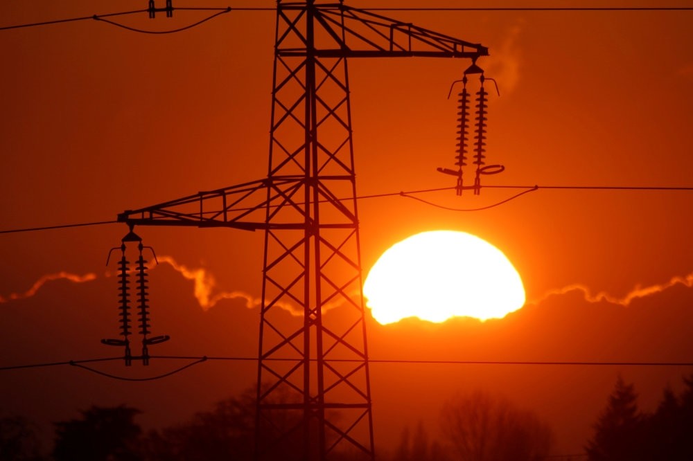 Electrical power pylons of high-tension electricity power lines are seen at sunset in Cambligneul near Arras, France.