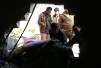 Refugees try to safe their belongings from a makeshift tent that was reportedly damaged by a mortar shell allegedly fired by the YPG in Atma, a town in the northern countryside of Idlib, Syria.