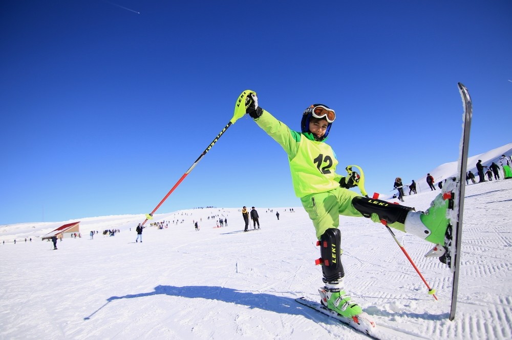 A boy enjoys his time skiing during semester break.