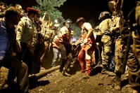 Rescue workers carry the body of a coal miner after he was pulled out from a mine in Azadshahr, in northern Iran. (AFP Photo)