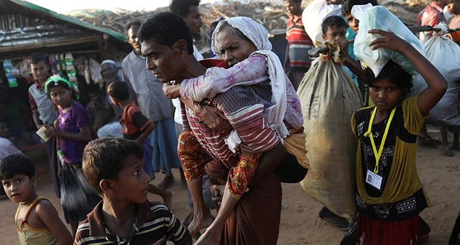 Rohingya Refugee Suray Khatun 70 Is Carried By Her Son Said A Rohingya Refugee Suray Khatun 70 Is Carried By Her Son Said A