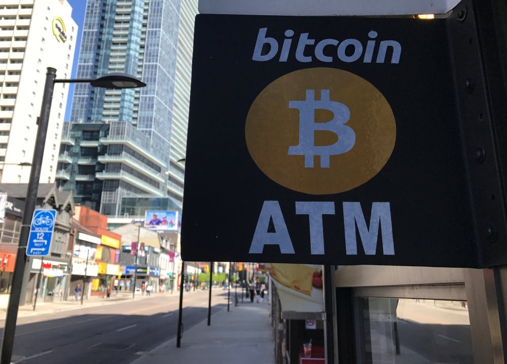 A sign seen outside a business where a Bitcoin ATM is located in Toronto, Canada.