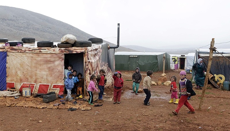 Children play outside their tent at an unofficial refugee camp in Jabaa, a village in the Bekaa Valley in Lebanon  (AFP File Photo)