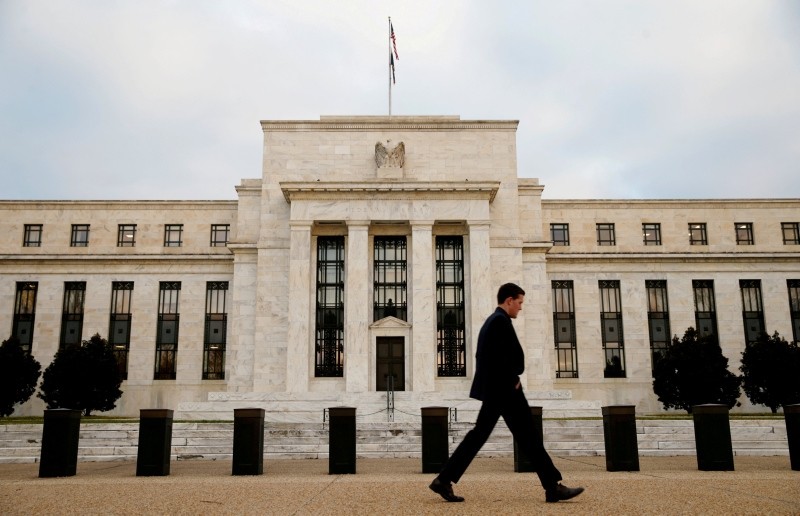 A man walks past the Federal Reserve Bank in Washington, D.C., U.S. December 16, 2015 (Reuters File Photo)