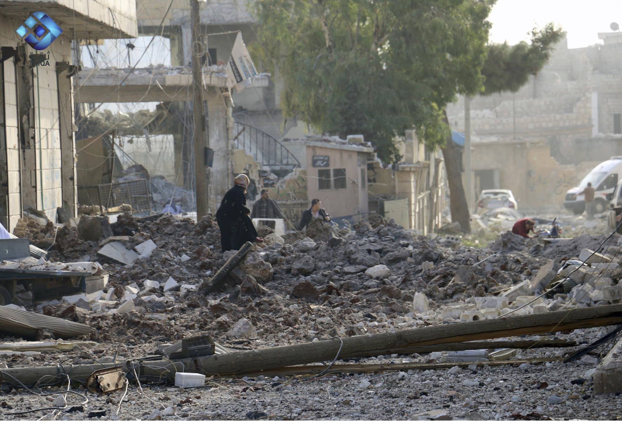 This image shows people inspecting damage from airstrikes on Atareb, in the opposition-held countryside outside Aleppo Syria, Monday, Nov. 13, 2017. (Thiqa News via AP)