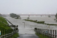 Swollen water levels along Tama river are pictured after heavy rains brought by approaching Typhoon Hagibis hit the Tokyo area on October 12, 2019 (AP Photo)