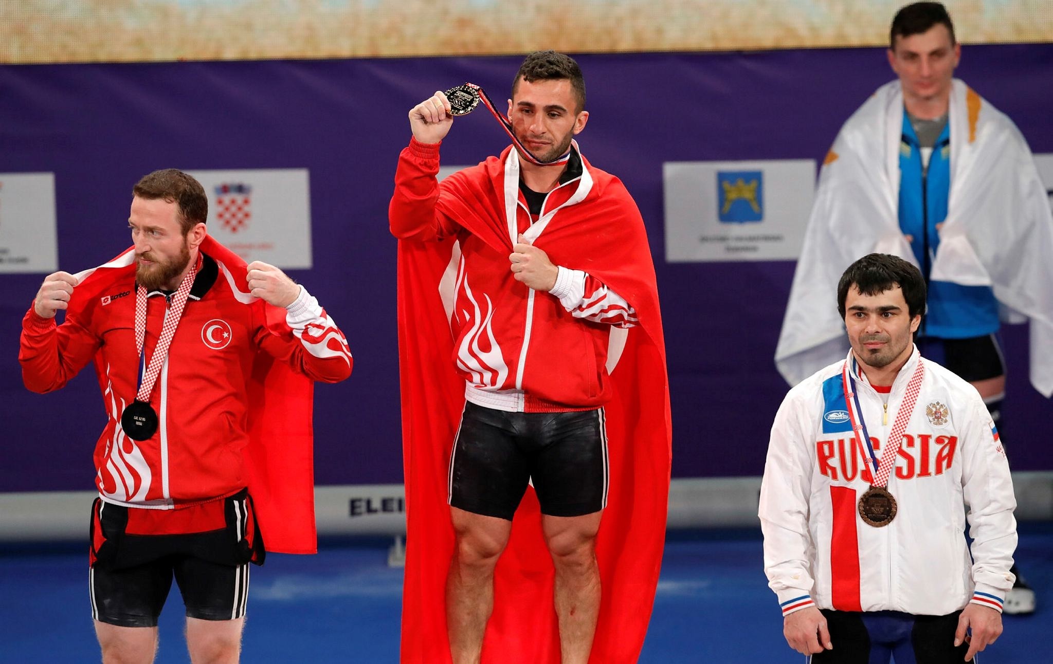 Second placed Bu00fcnyamin Sezer (L) and winner Huru015fit Atak (C) with third placed Feliks Khalibekov of Russia