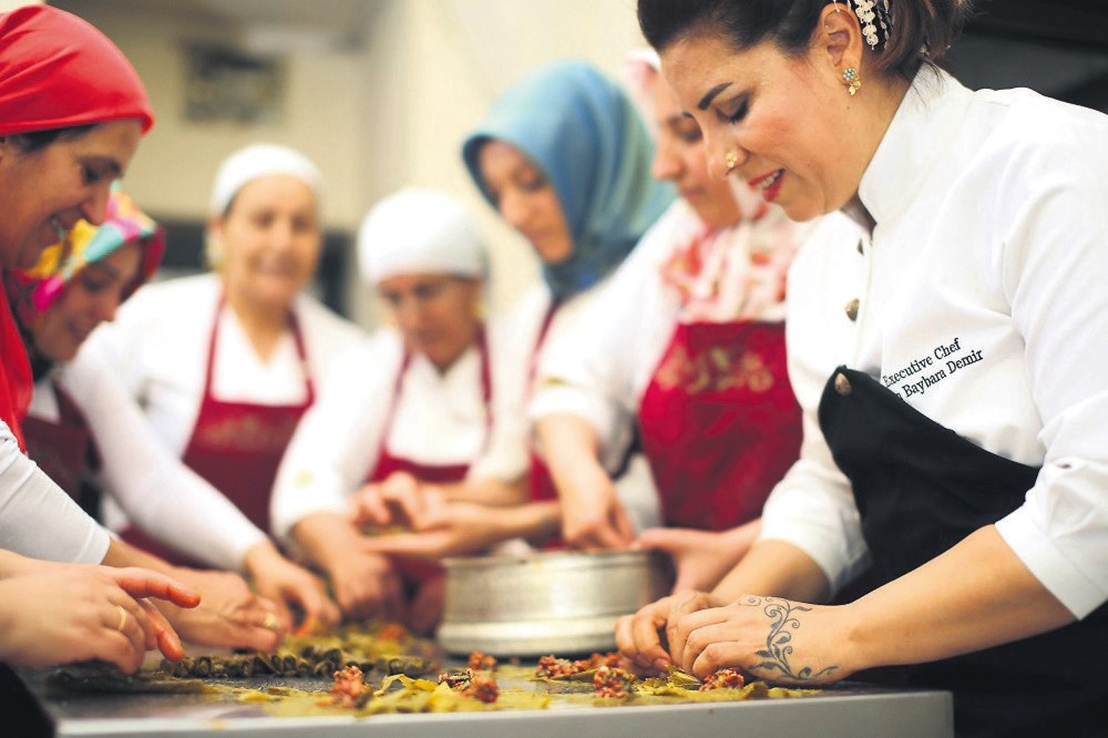 Entrepreneur chef Ebru Baybara Demir, right, working with her fellow cooks.