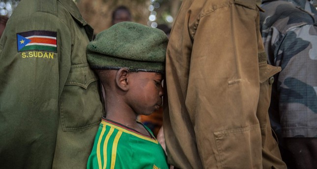 A newly released child soldier waits in a line for his registration during a ceremony in Yambio, South Sudan, Feb.7.