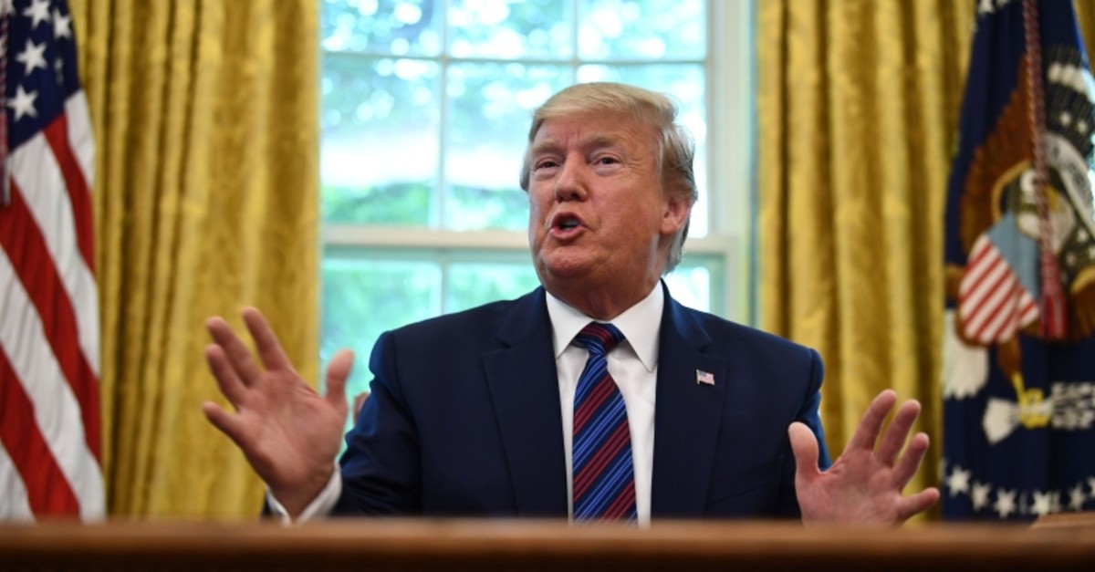 US President Donald Trump speaks to the media in the Oval Office of the White House in Washington, DC on July 26, 2019. (AFP Photo)