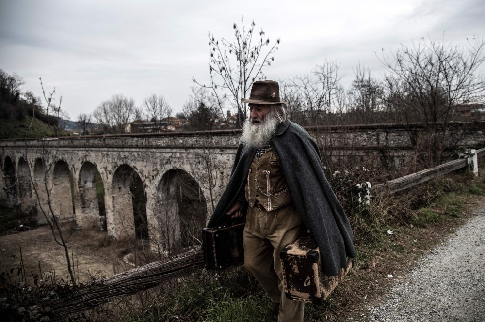 Mario Collino walks on a path toward the village of Busca.