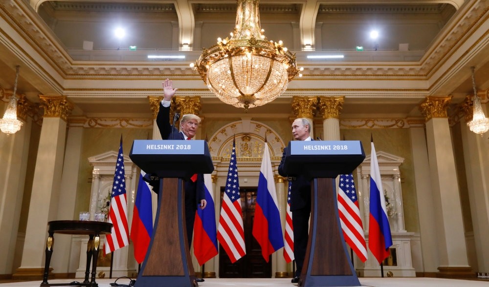 U.S. President Donald Trump (L) waves after a joint news conference with Russia's President Vladimir Putin following their meeting in Helsinki, Finland, July 16, 2018.
