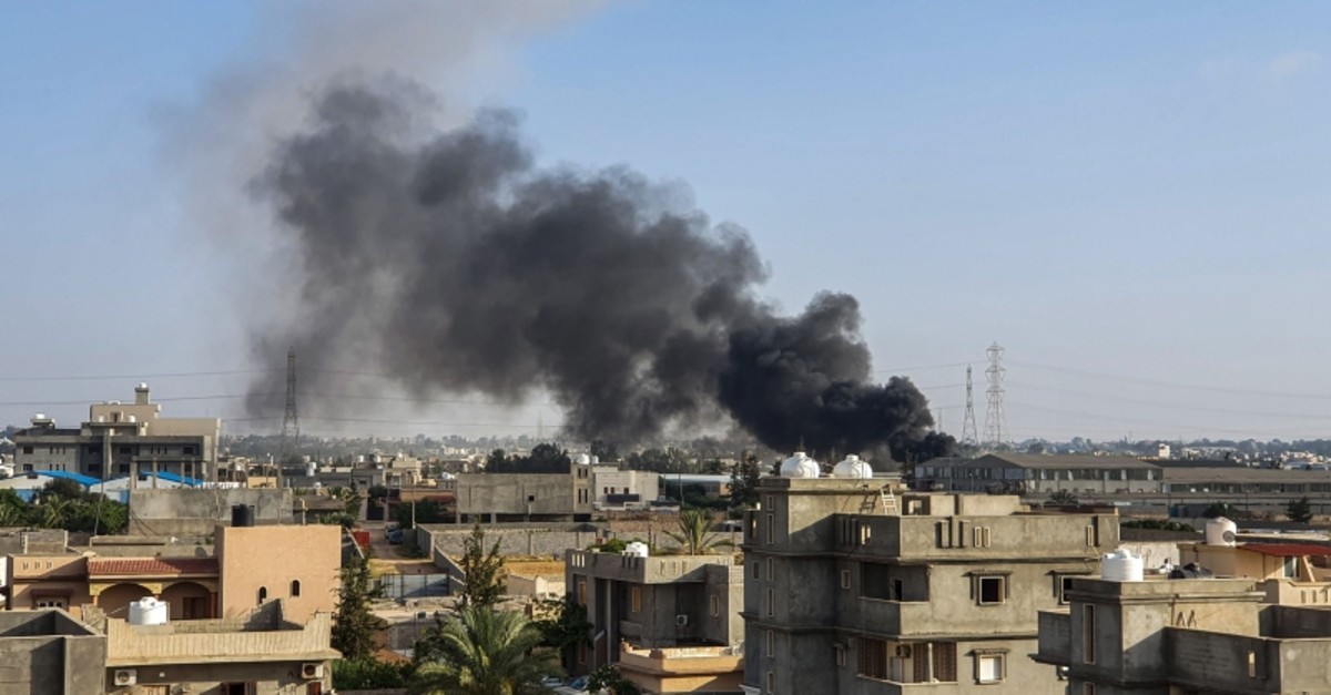 This picture taken on June 29, 2019 shows smoke plumes rising in Tajoura, south of the Libyan capital Tripoli, following a reported airstrike by forces loyal to warlord Khalifa Haftar (AFP Photo)